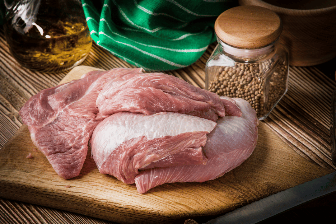 raw turkey meat on a cutting board